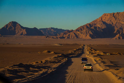 Scenic view of road and mountains against sky