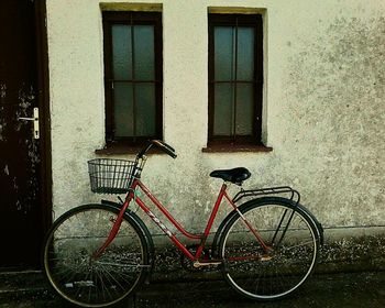 Bicycle parked against building