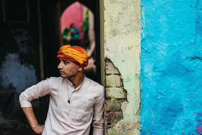 Full length of man standing against wall