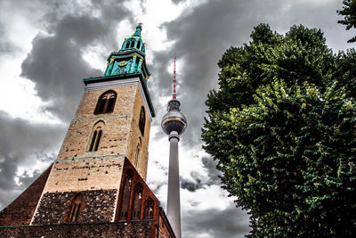 Low angle view of building against cloudy sky