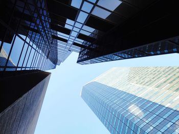 Directly below shot of modern buildings against clear sky in city