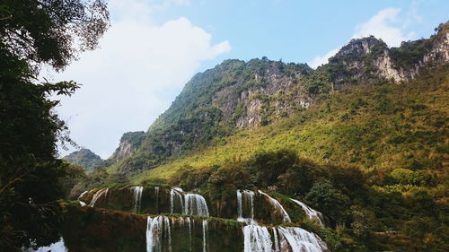 Low angle view of waterfall against sky