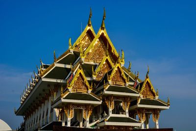 Low angle view of pagoda against blue sky