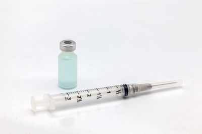 High angle view of bottle on table against white background