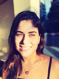 Close-up portrait of a smiling young woman