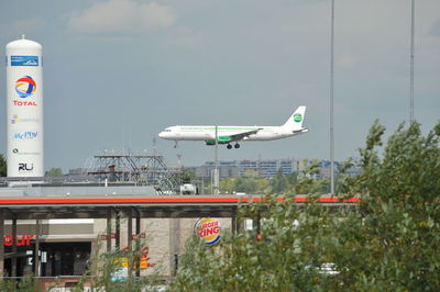 Airplane against sky in city