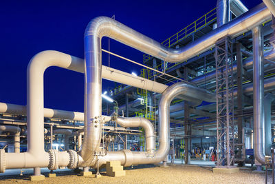 View of a gas refinery plant illuminated at dusk.