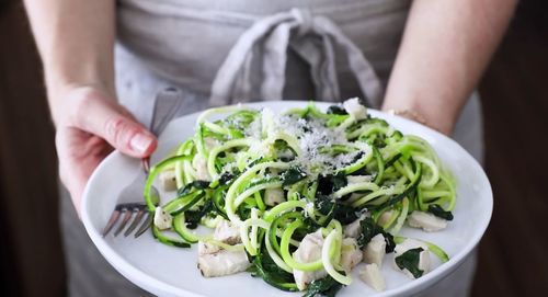 Midsection of woman holding salad