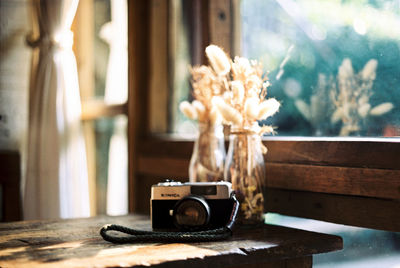 Close-up of camera on table at home