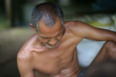 Midsection of shirtless man