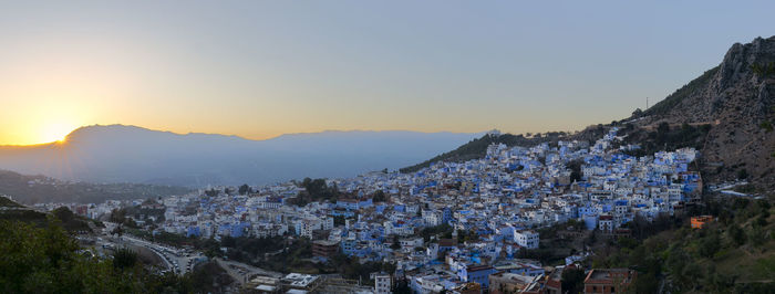 Aerial view of townscape against clear sky during sunset