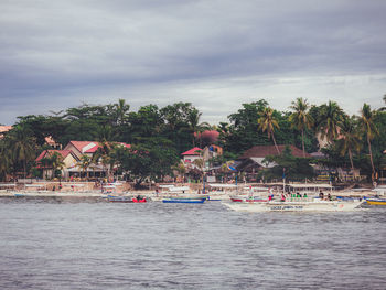 Boats in sea against sky