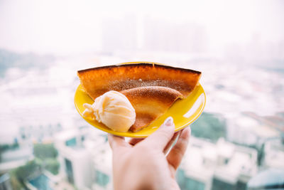 Cropped hand holding ice cream