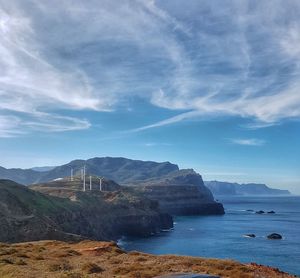 Scenic view of bays and volcanic cliffs against sky