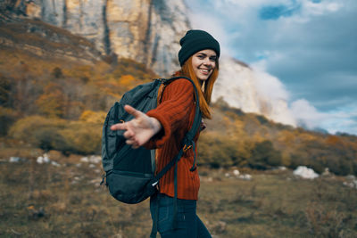 Portrait of smiling young woman standing outdoors