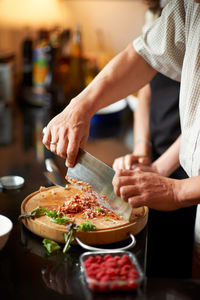 Midsection of man preparing food