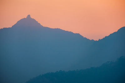 Scenic view of silhouette mountains against sky during sunset