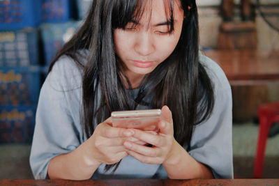 Midsection of woman using mobile phone