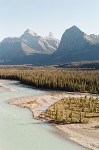 Scenic view of lake and mountains against clear sky