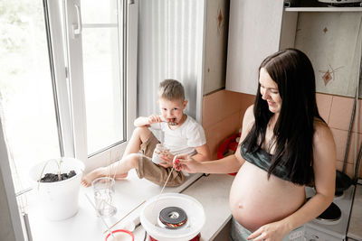 Mother and daughter sitting on floor