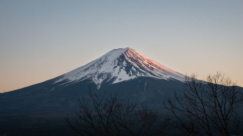 Scenic view of snowcapped mountains against clear sky during winter