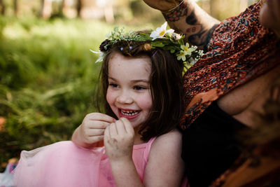 Portrait of happy girl holding plant