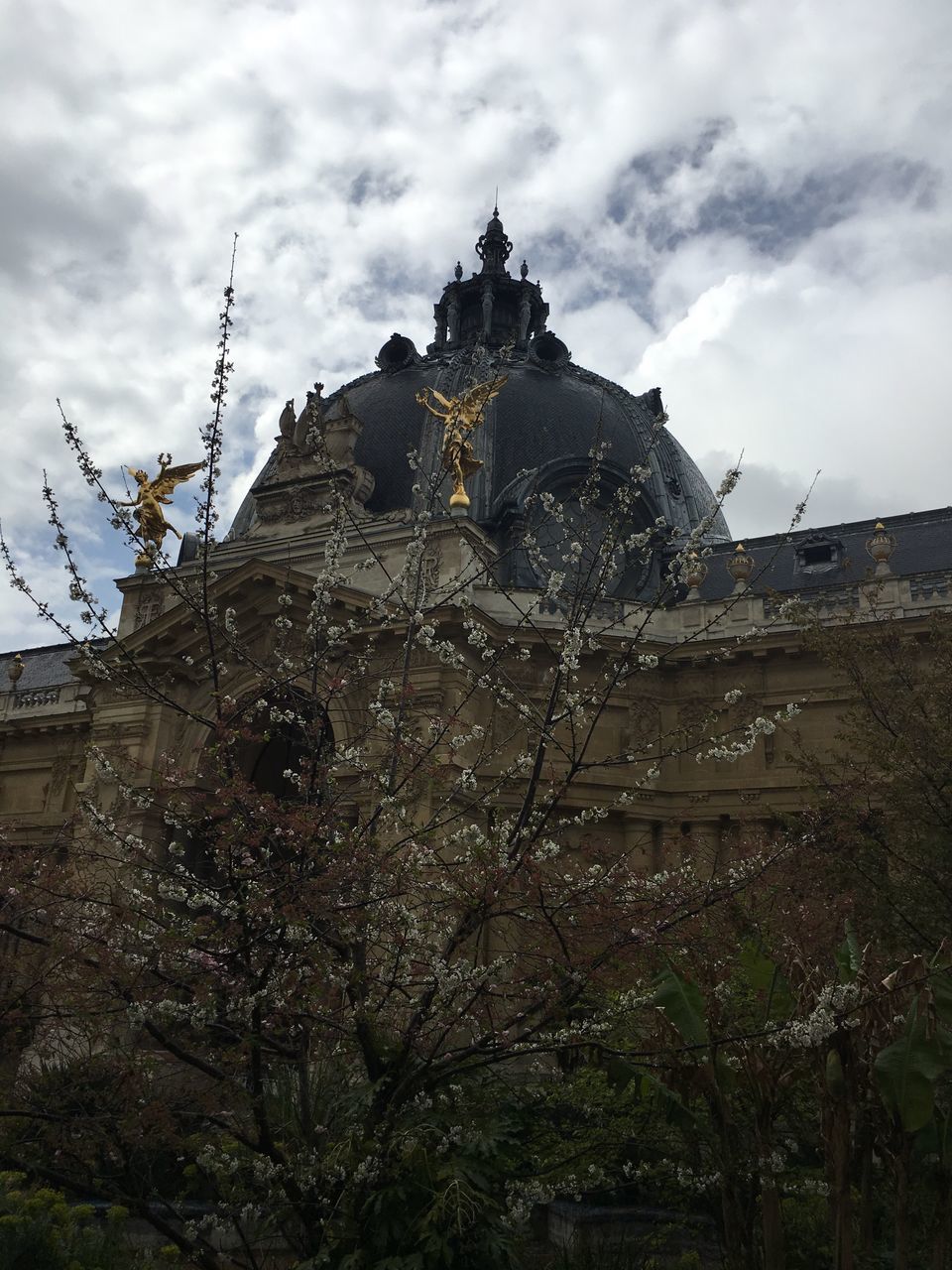 sky, architecture, building exterior, built structure, cloud - sky, mountain, religion, cloudy, history, cloud, place of worship, spirituality, famous place, low angle view, travel destinations, tree, day, outdoors, travel