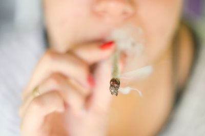 Close-up of woman smoking weed