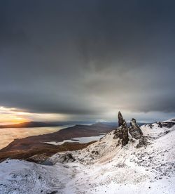 Scenic view of snowcapped mountain against sky during sunset