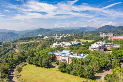 High angle view of trees and buildings against sky