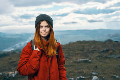 Portrait of young woman standing in snow