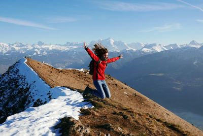 Woman jumping on mountain