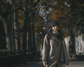 Portrait of woman standing in park