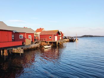 Houses by sea against sky