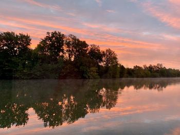 Scenic view of lake against sky at sunset