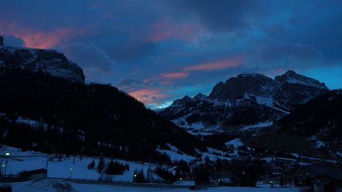 Scenic view of snowcapped mountains against sky during sunset