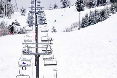 Ski lift on snow covered field