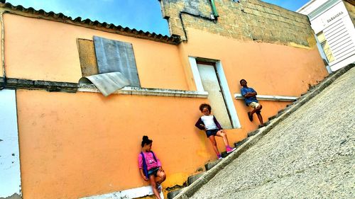 Low angle view of people walking on building