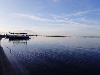 Boat moored in sea against sky