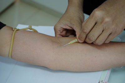 Close-up of doctor giving injection to patient 