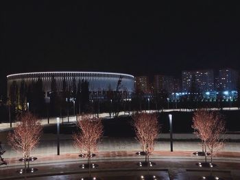 Illuminated city against clear sky at night