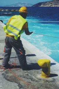 Man working with umbrella on sea shore