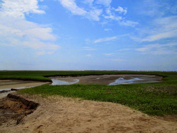 Scenic view of sea against cloudy sky