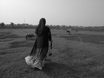 Woman on field against clear sky