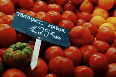 Tomatoes with price tag for sale in market