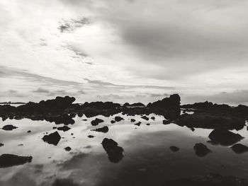 Scenic view of calm sea against cloudy sky