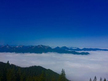 Scenic view of mountains against blue sky