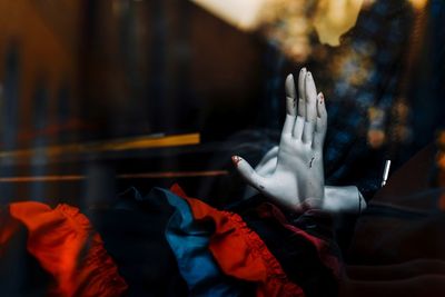 Close-up of mannequin seen through store window