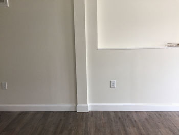 White wooden floor against wall at home