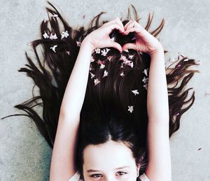 High angle portrait of girl lying down on bed